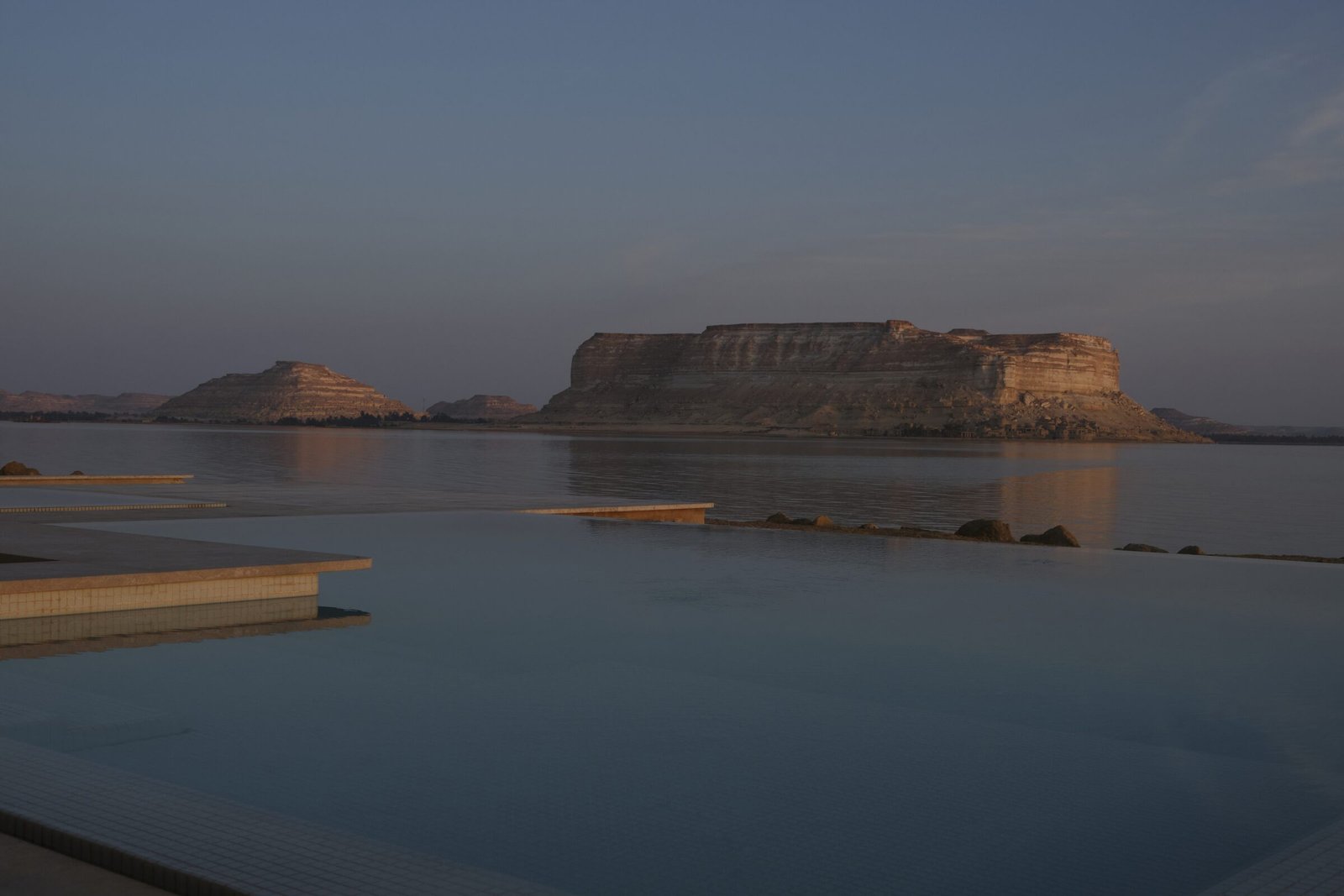 The mirror surface of Lake Siwa at dawn